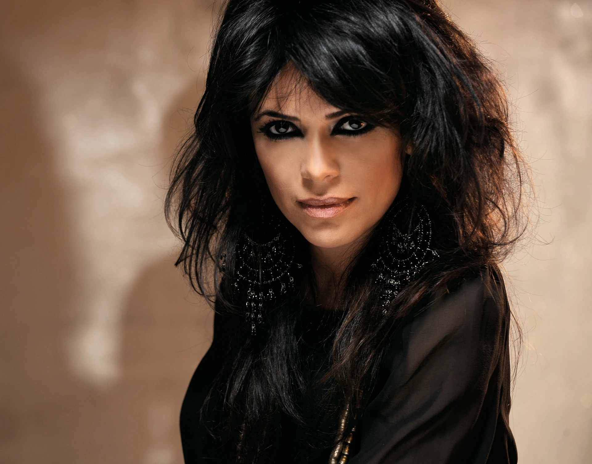 Yasmin Levy wearing black against a light-brown background