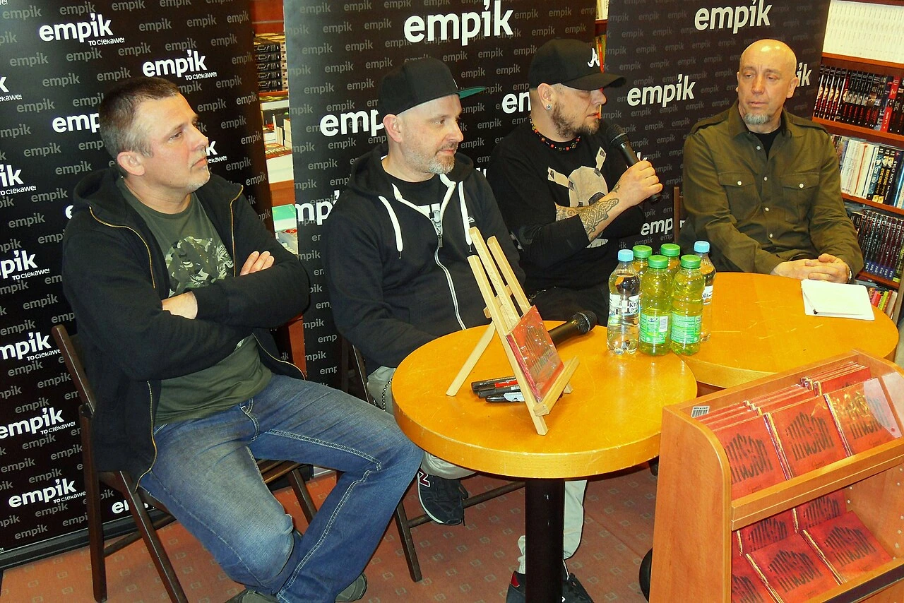 Members of Illusion seated at a table at an event in Gdańsk in 2014