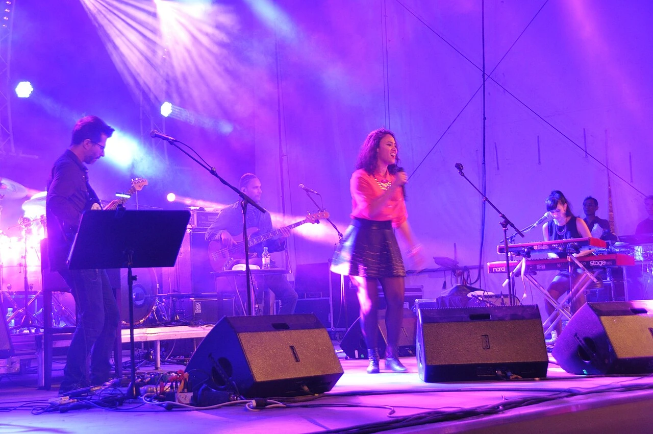 Mayra Andrade and her band on the illuminated stage at Horizonte Festival in Koblenz in 2014