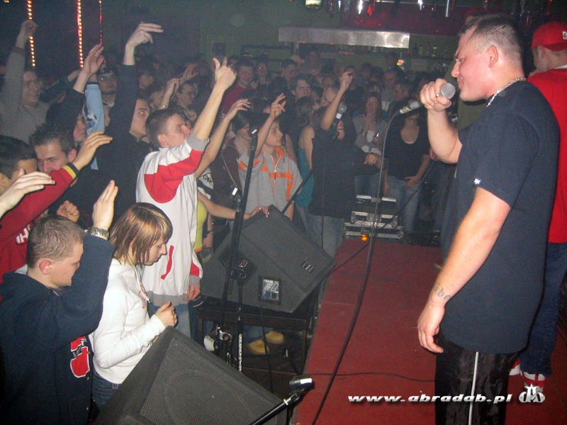 Abradab performing with a microphone in front of a club audience