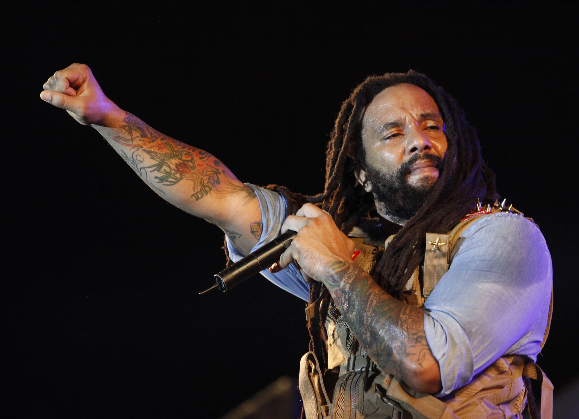 Ky-Mani Marley holding a microphone during a stage performance