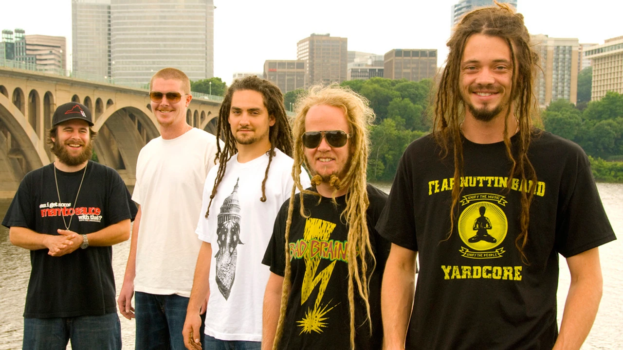 SOJA musicians posing outdoors in an urban setting