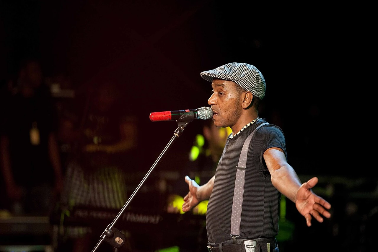 Tito Paris singing into a microphone during a performance in 2010
