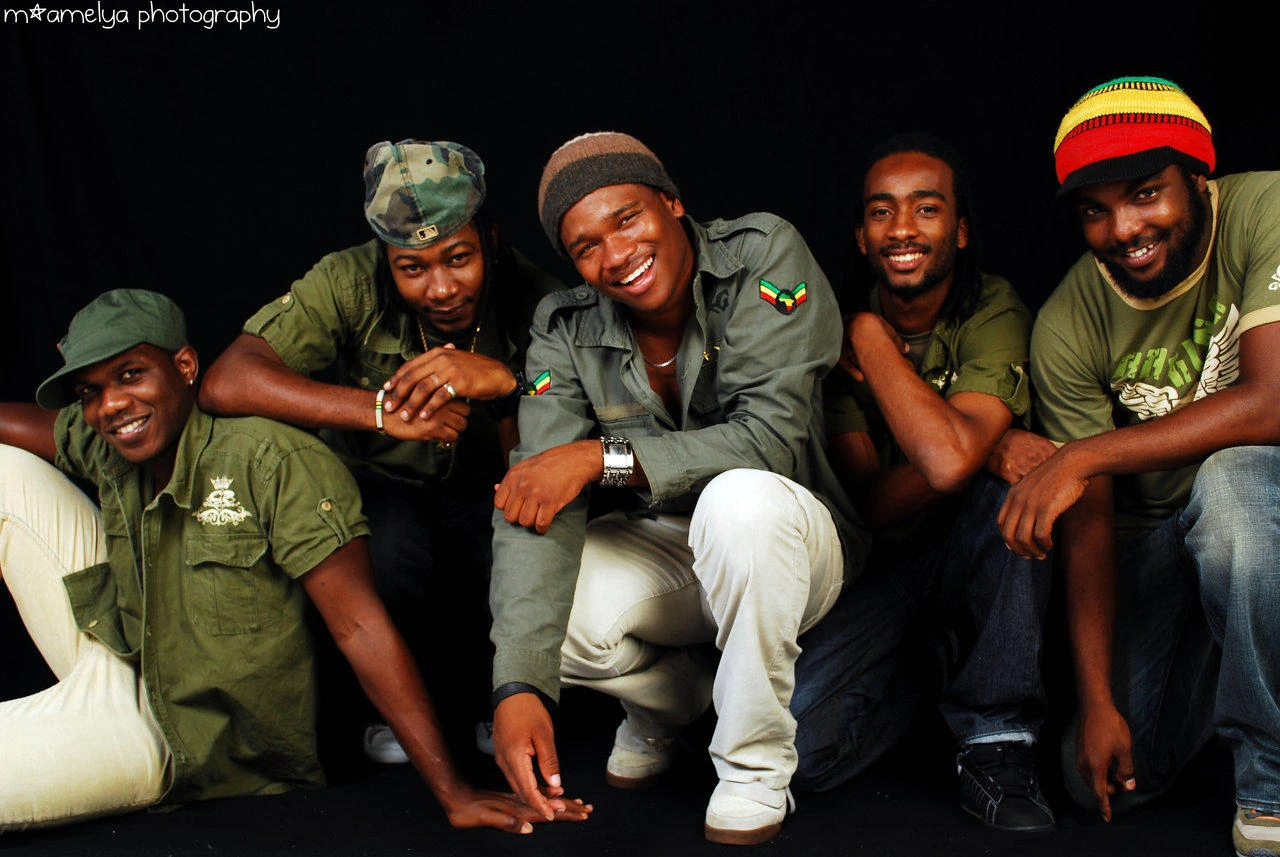 Raging Fyah musicians in a group portrait wearing shades of green