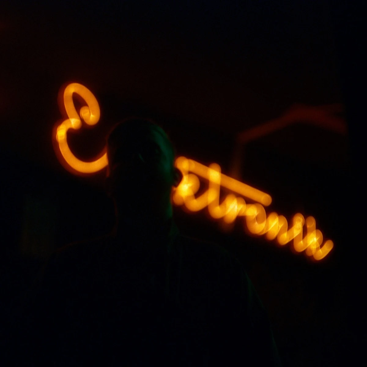 NOON in an artistic photograph with a blurred neon sign