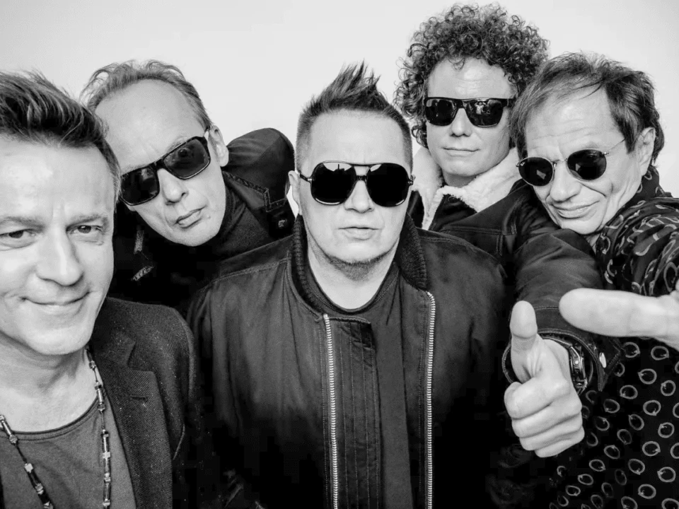 Five T.Love musicians in a black-and-white band photograph